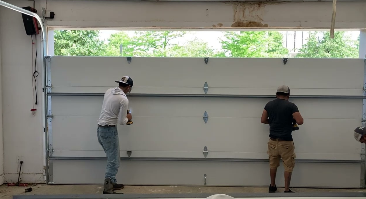 A trained technician from Alum Creek Garage Doors Repair working on a garage door spring repair to ensure smooth functionality