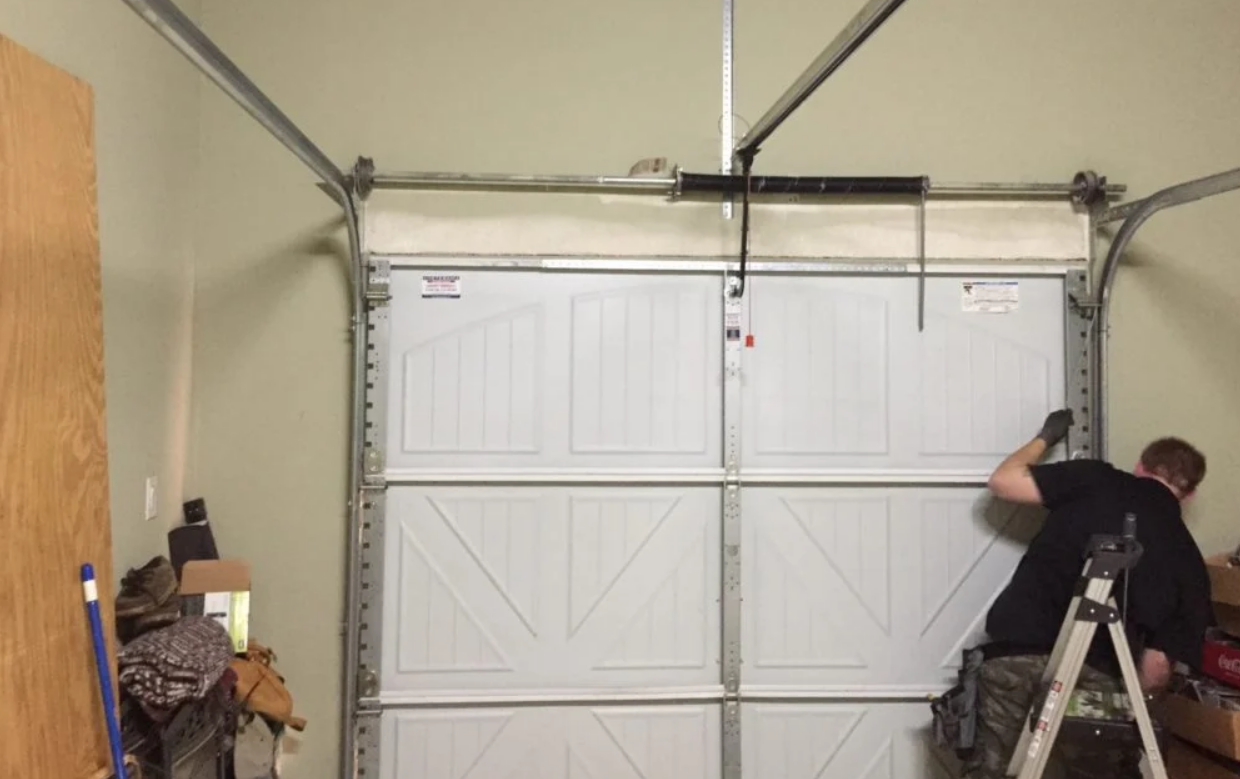 Professional garage door installation by Alum Creek Garage Doors Repair, showcasing a sleek, modern door being fitted into a residential garage.
