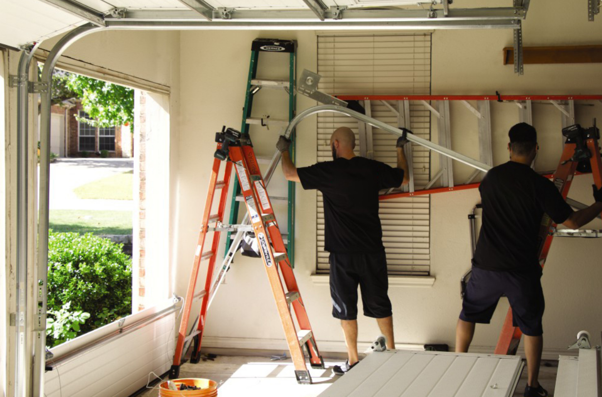A technician performing a garage door section replacement on a residential garage door in Alum Creek, ensuring smooth operation and durability.
