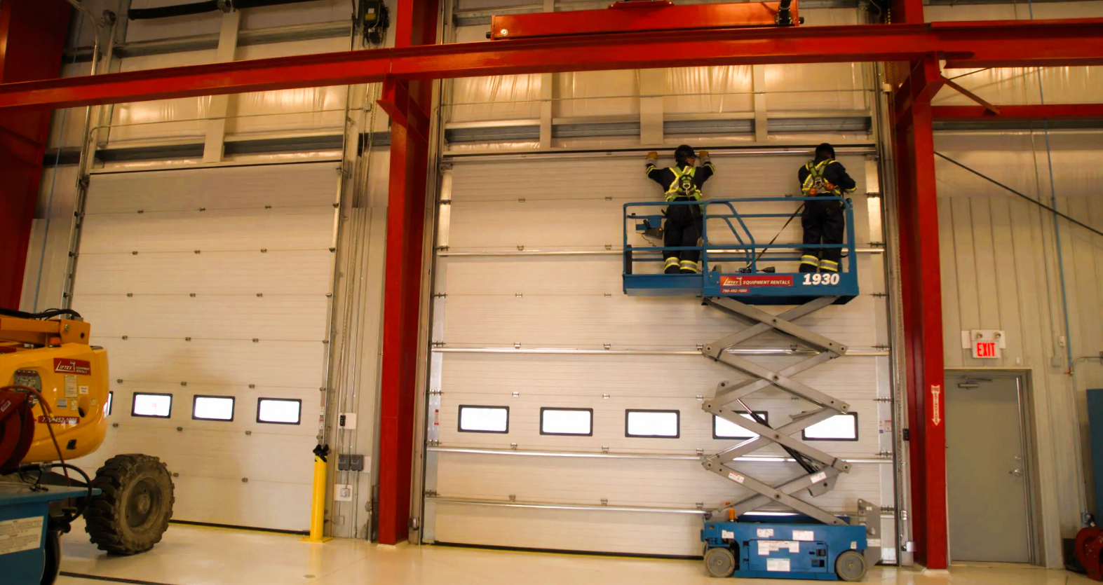 Technician repairing a commercial garage door for Alum Creek Garage Doors Repair.