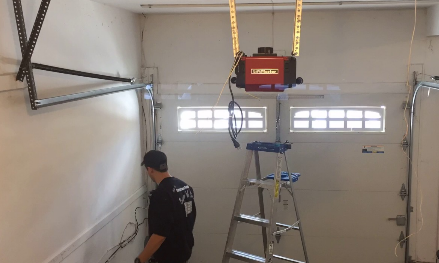 echnician performing a professional garage door opener installation for a residential garage in Alum Creek