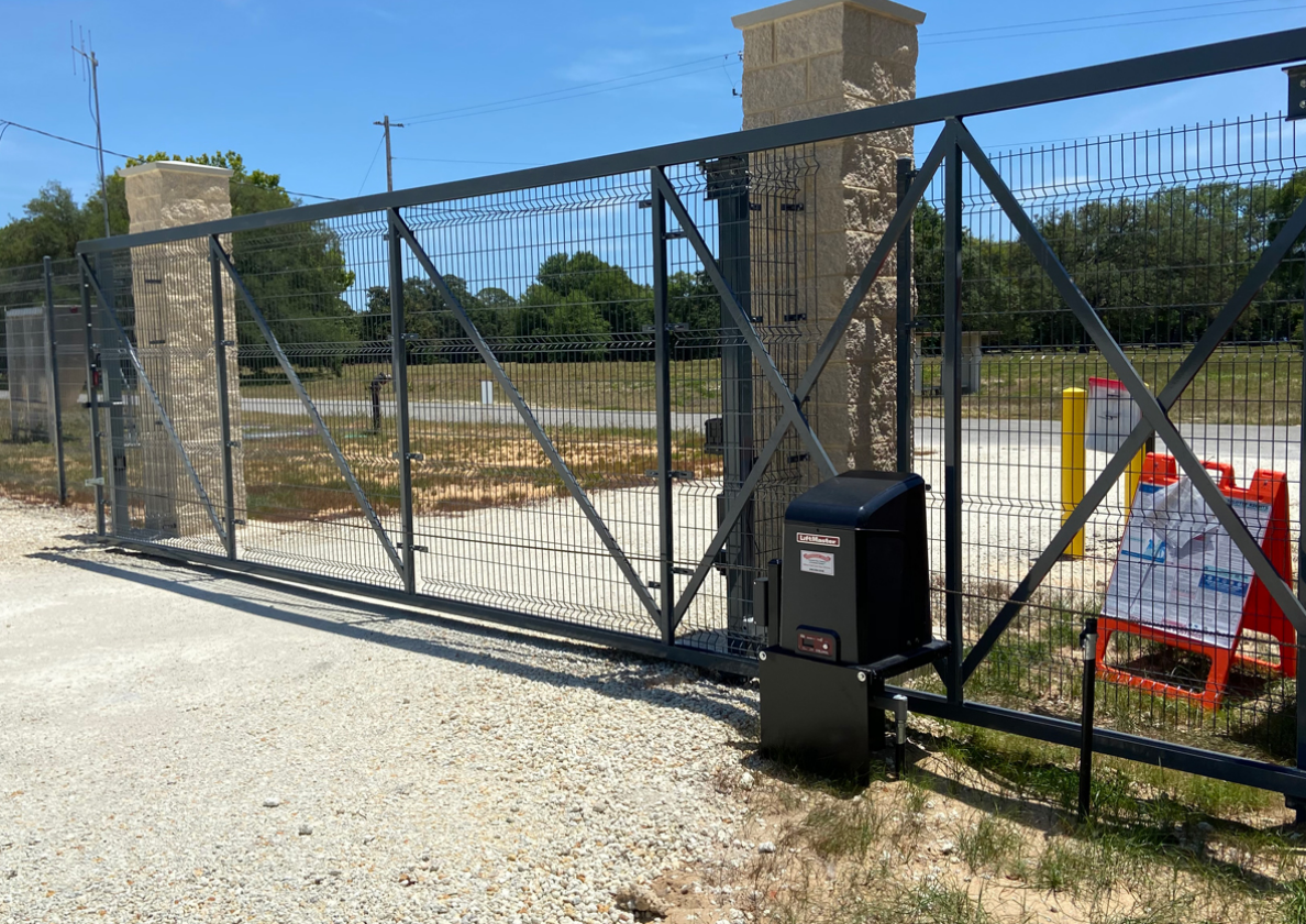 Technician performing commercial gate repair on a sliding metal gate for Alum Creek Garage Doors Repair.