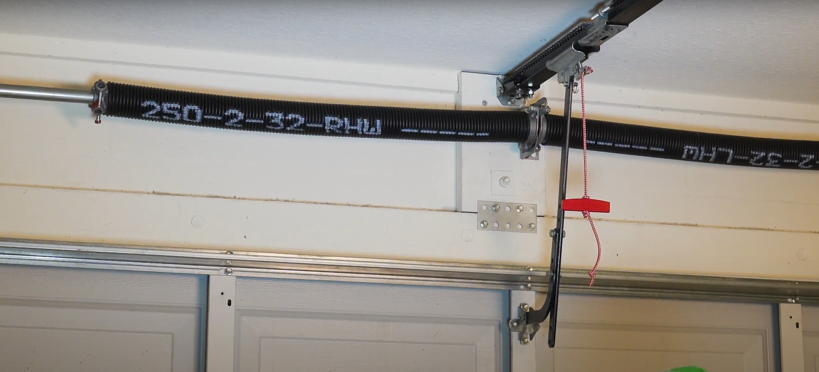 A professional technician inspecting garage door springs. ("Certified technician from Alum Creek Garage Doors Repair examining garage door springs for repair.")